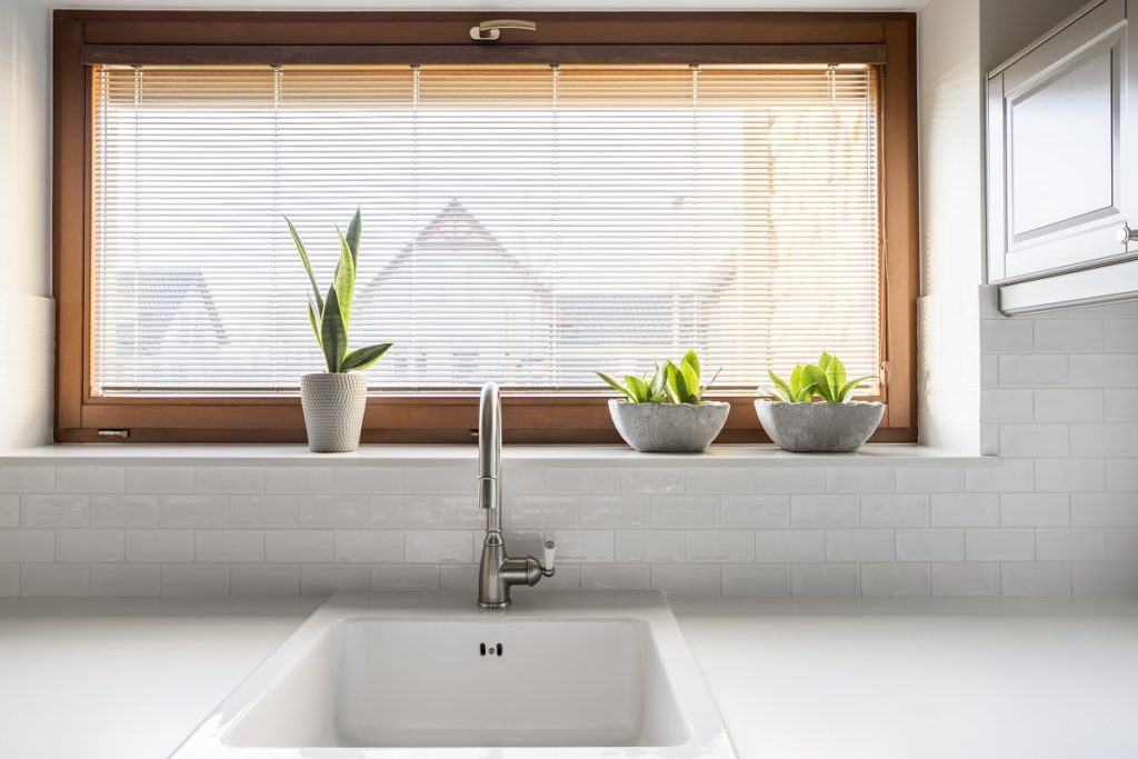 Kitchen with white sink, countertop and window